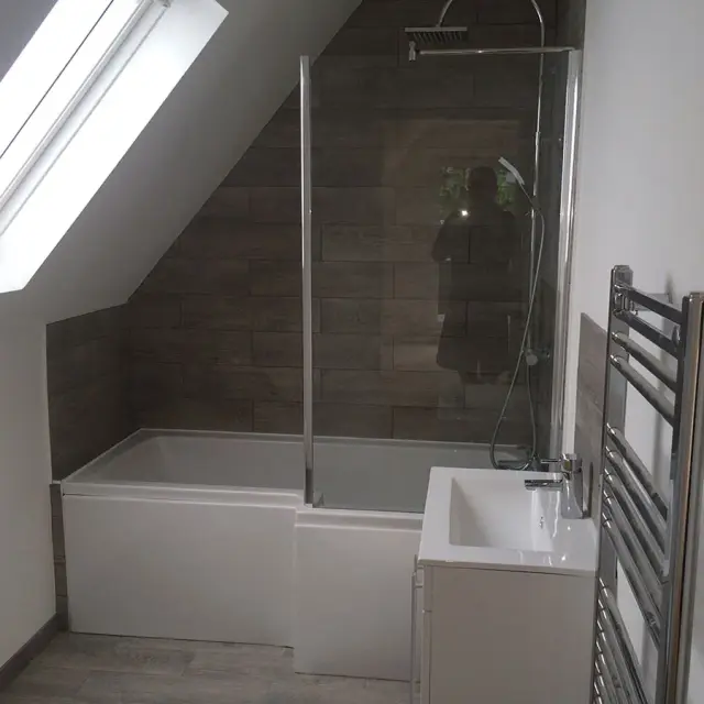 Loft bathroom with bath under sloped ceiling