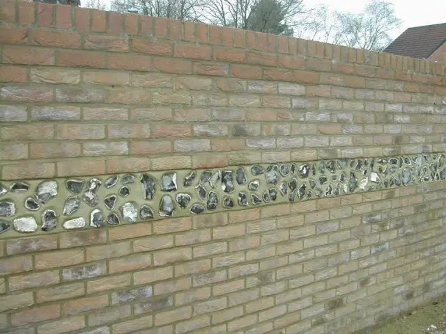 Brick garden wall with flint stone detailing