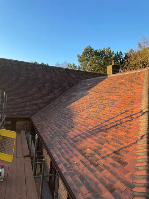 The new clay tiled roof finished alongside the existing roof