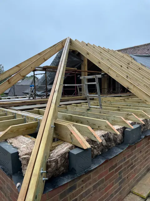 A hip rafter running down to the corner of the new roof