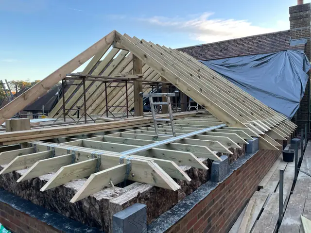 The new roof frame over the extension, with the existing roof sheeted where the two meet