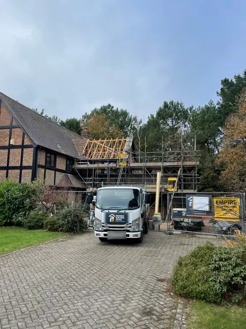 Scaffolding and new roof timbers at the front of the house, with our truck on the drive