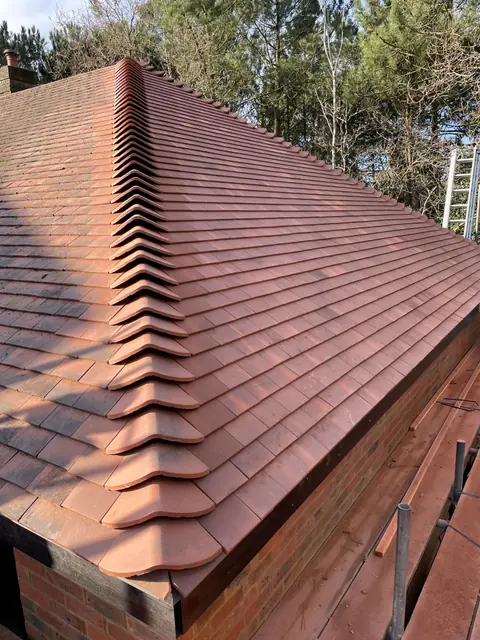 A finished clay tiled hip on the new roof