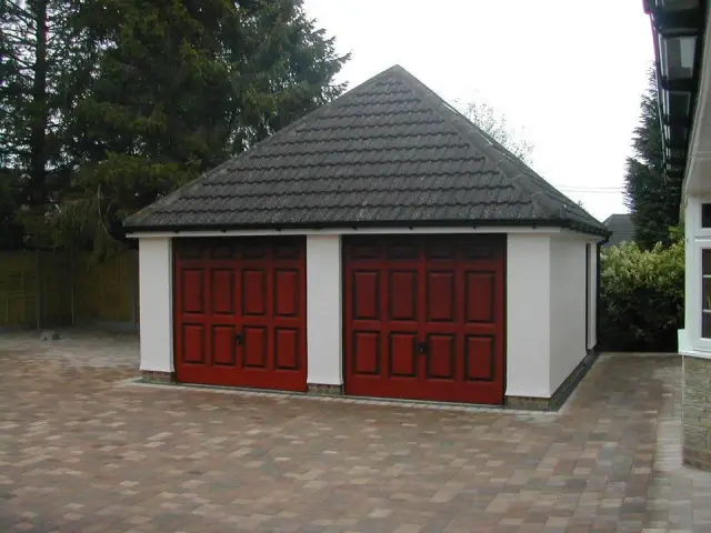 Detached double garage with red timber doors