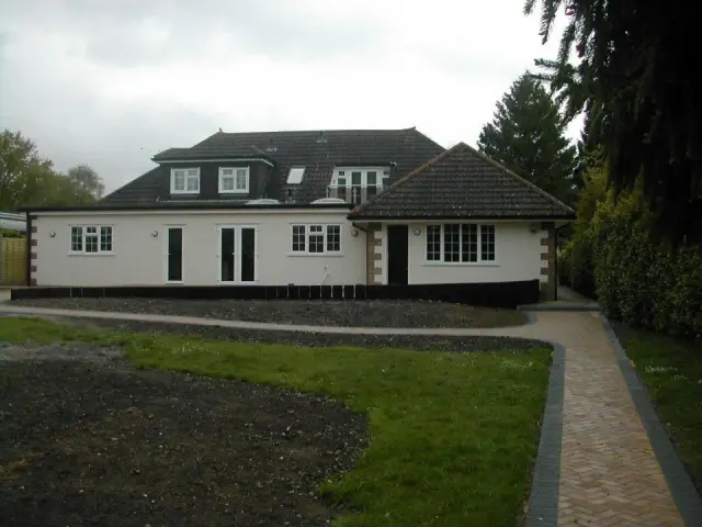 Renovated bungalow with white render and dormers