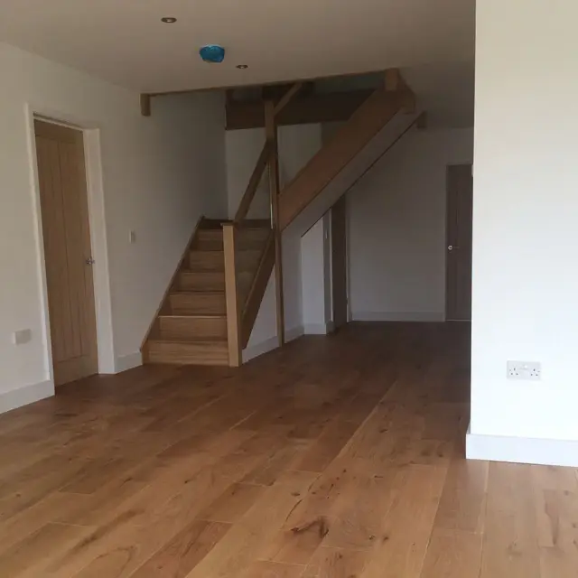 Open-plan hallway with oak staircase and flooring
