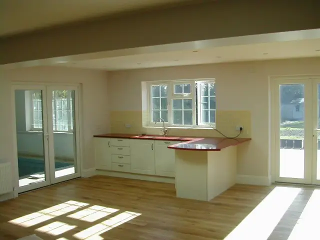 Open-plan kitchen area beside indoor pool room