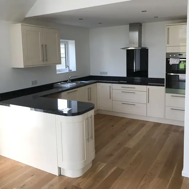 Cream shaker kitchen with black granite worktops