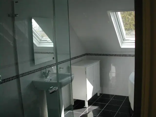 Loft conversion bathroom with skylight window