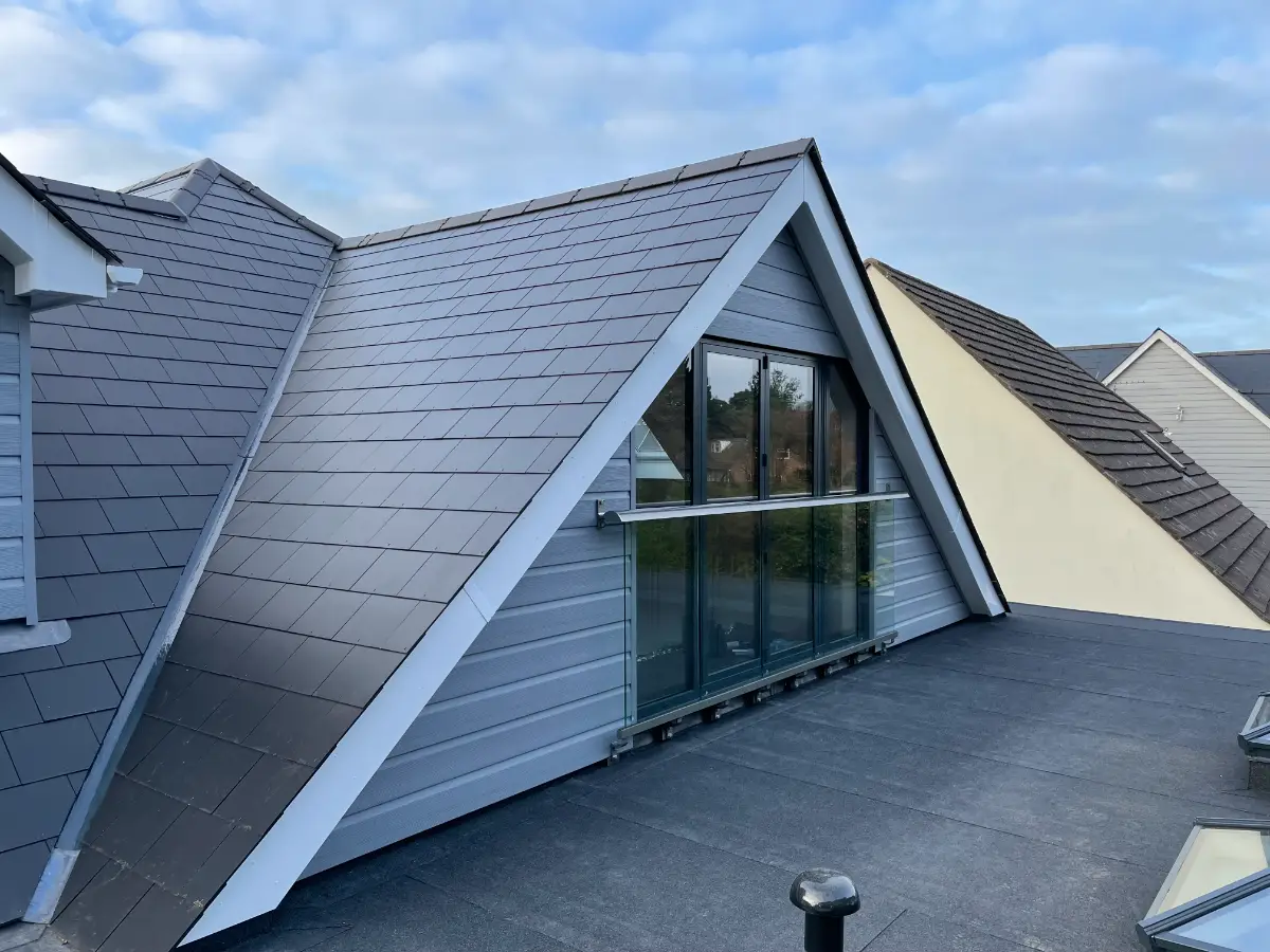 Loft dormer with balcony and grey cladding