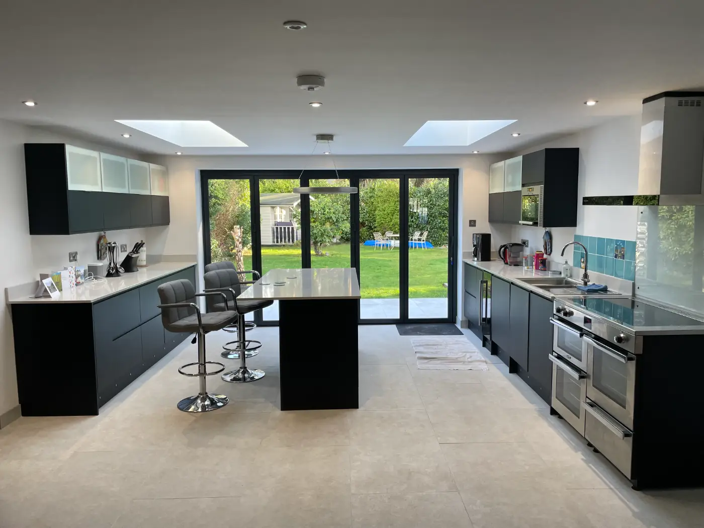 Open-plan kitchen extension with an island and roof lanterns