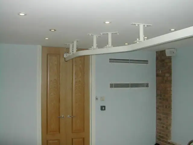 Ceiling-mounted curved track above panelled doors