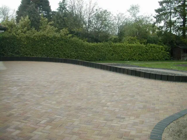 Block paved driveway with curved brick edging
