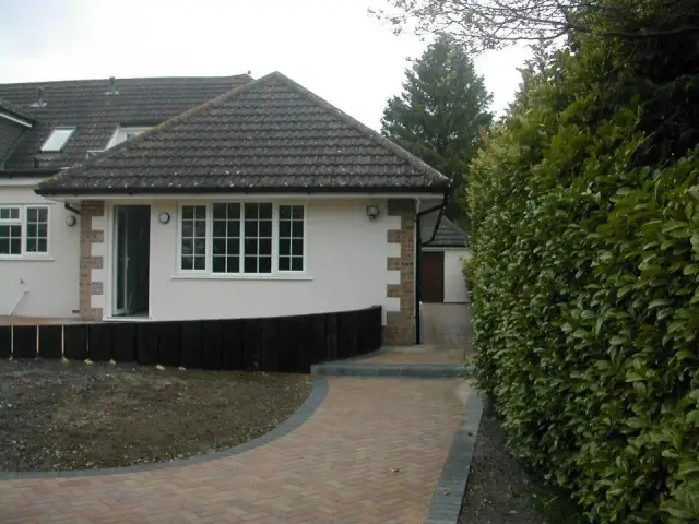Rendered bungalow extension with block driveway