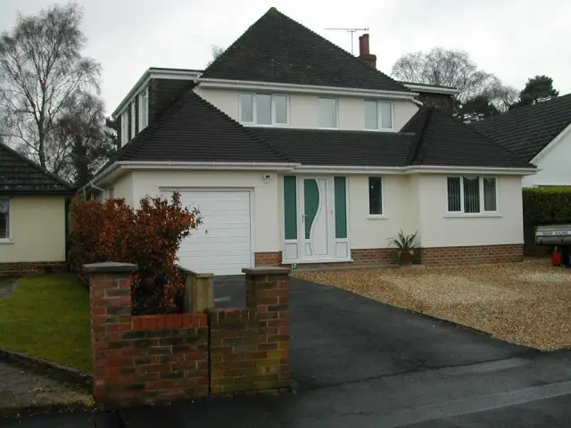 White rendered dormer bungalow with garage