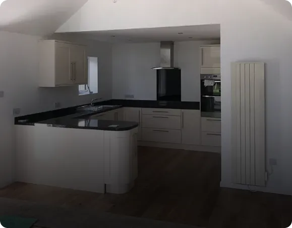Modern fitted kitchen design with dark worktops